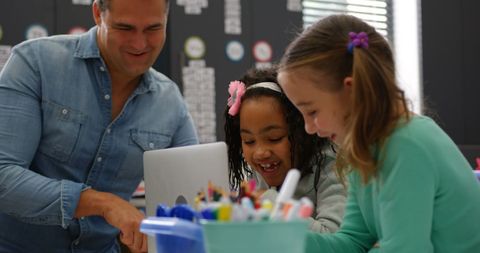 Father and daughters engaged in educational activity at home
