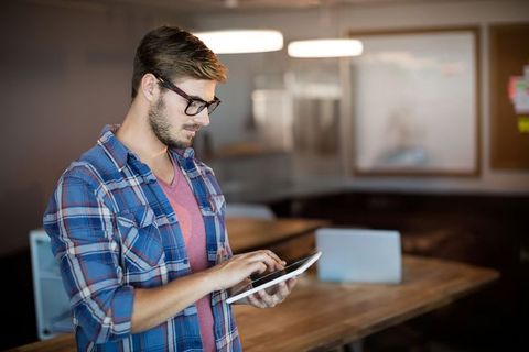 Bearded Professional Using Tablet in Modern Office Environment - Download Free Stock Images Pikwizard.com