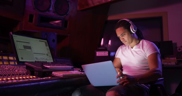 Focused Music Producer Using Laptop in Recording Studio in Evening - Download Free Stock Images Pikwizard.com