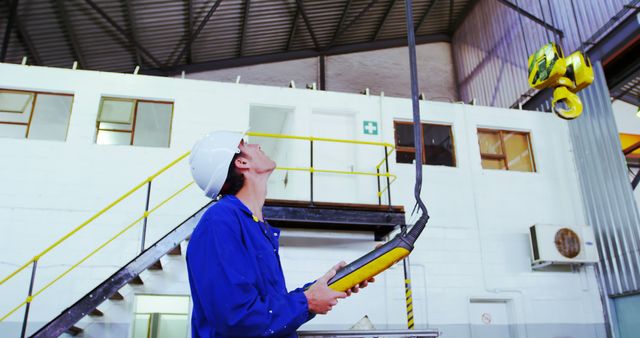 Factory Worker Controlling Overhead Crane with Remote - Download Free Stock Images Pikwizard.com