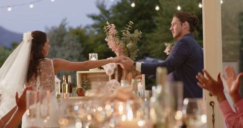 Newlyweds Dancing Joyfully at Outdoor Wedding Reception