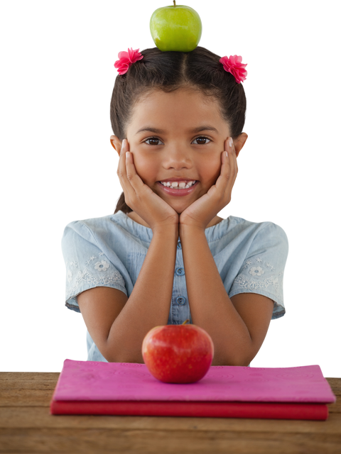 Smiling girl with Granny Smith apple on head in classroom - Download Free Stock Videos Pikwizard.com