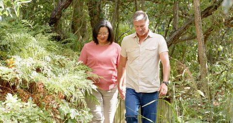 Couple Exploring Woodland Serenity on Boardwalk