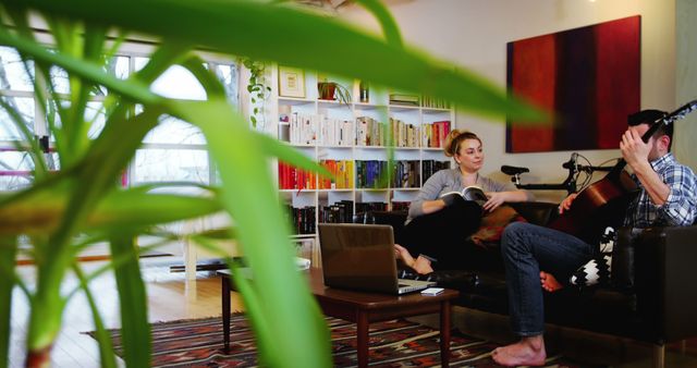 Young Couple Enjoying Relaxing Moment at Cozy Home with Guitar and Book - Download Free Stock Images Pikwizard.com