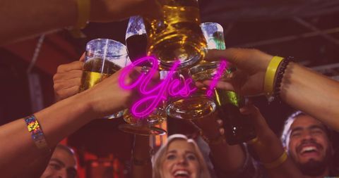 Diverse Friends Toasting Drinks in Lively Night Out Celebration