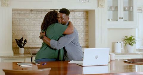 African american couple embracing while discussing plans at home