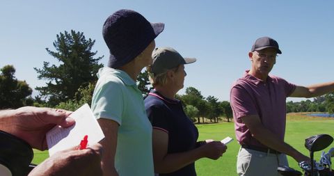 Senior Couple Tracking Golf Score on Sunny Day