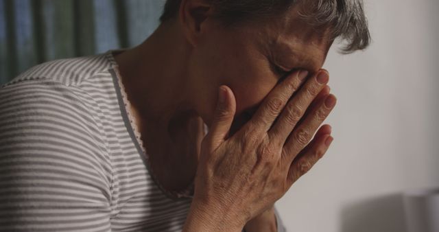 Elderly Woman In Striped Shirt Grieving - Download Free Stock Images Pikwizard.com