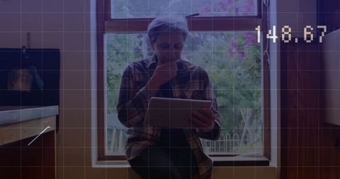 Senior Woman Analyzing Financial Data on Digital Tablet