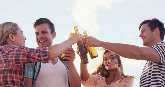 Group of Friends Toasting with Beer Bottles at Outdoor Party - Download Free Stock Images Pikwizard.com