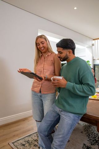 Diverse Friends Relaxing with Tablet in Modern Lounge