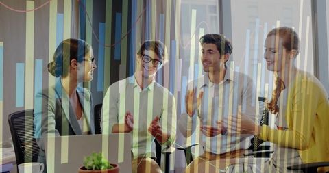 Collaborative Business Team Looking at Laptop in Meeting Room