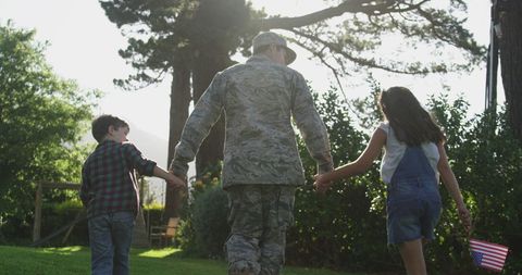 Soldier Reunites with Children During Homecoming in Garden - Download Free Stock Images Pikwizard.com