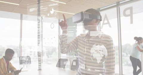 Woman wearing vr headset interacting with holographic interface in collaborative workspace