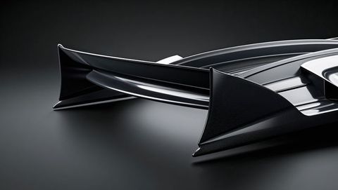 Sleek black automotive spoiler highlighting aerodynamic design and streamline form