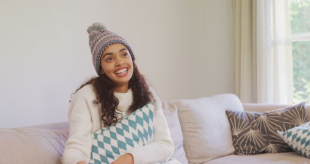 Smiling Woman Relaxing on Couch with Pillow in Bright Living Room - Download Free Stock Images Pikwizard.com