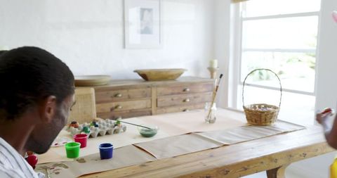 Father and Daughter Painting Together in Bright, Rustic Interior Home