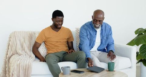 Father and Son Spending Quality Time at Home with Tablet