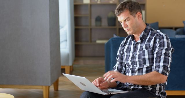 Businessman Working on Laptop in Modern Office Lounge Area - Download Free Stock Images Pikwizard.com