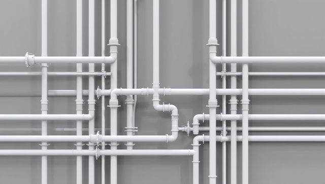 Dense white industrial pipe network with valves and elbow fittings on gray wall geometric