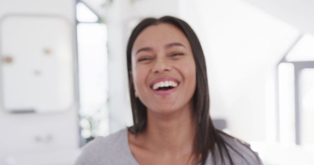 Smiling Young Adult Woman with Long Hair in Bright Room - Download Free Stock Images Pikwizard.com