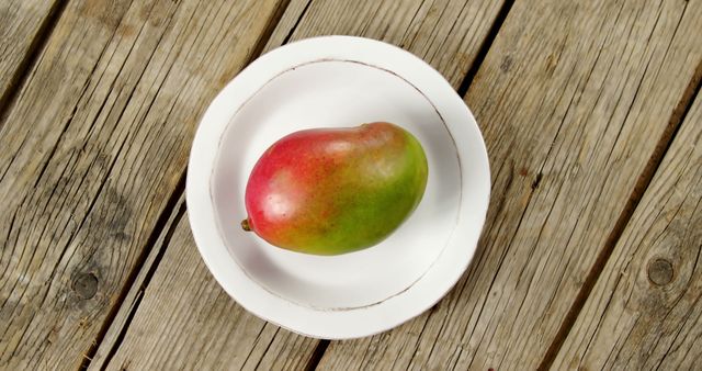 Ripe Mango on White Plate on Rustic Wooden Table - Download Free Stock Images Pikwizard.com