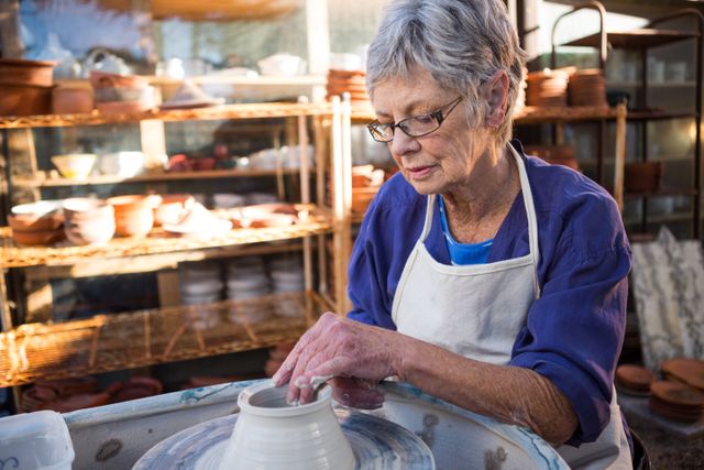Female potter making pot in pottery workshop