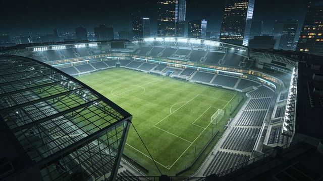 Floodlit urban soccer stadium with glass-roofed stand under night skyline
