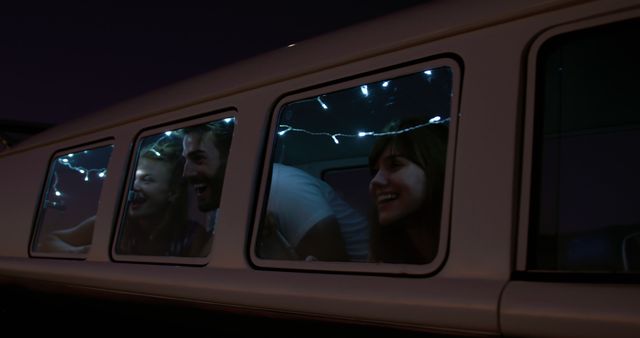 Friends Enjoying Night in Illuminated Campervan - Download Free Stock Images Pikwizard.com