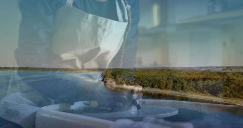 Mid-Adult Potter Shaping Clay on Wheel with River Landscape Double Exposure
