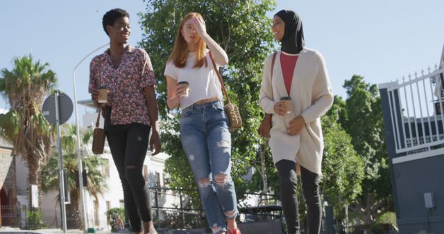 Diverse Female Friends Walking with Coffee on Sunny Urban Street - Download Free Stock Images Pikwizard.com