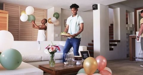 Friends Preparing Home for Birthday Celebration