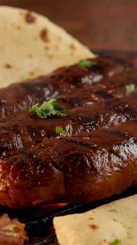 Sizzling BBQ Rib Rack Caramelizing on Grill Over Embers with Cilantro and Tortillas