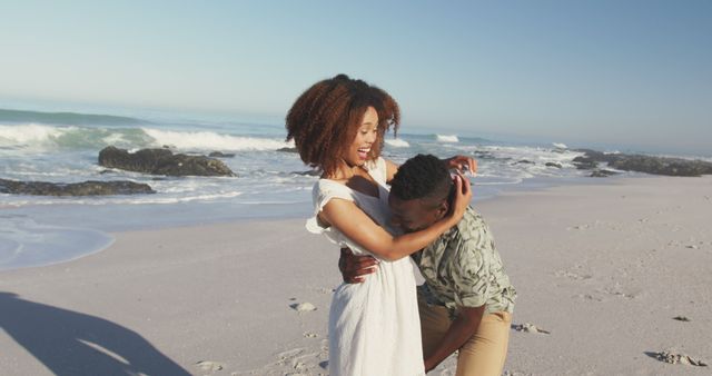 Smiling Couple Enjoying Playful Moment on Beach - Download Free Stock Images Pikwizard.com