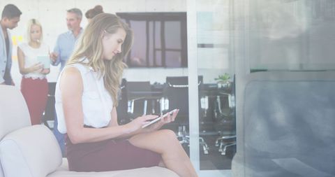 Businesswoman Engaged with Tablet Technology in Modern Office