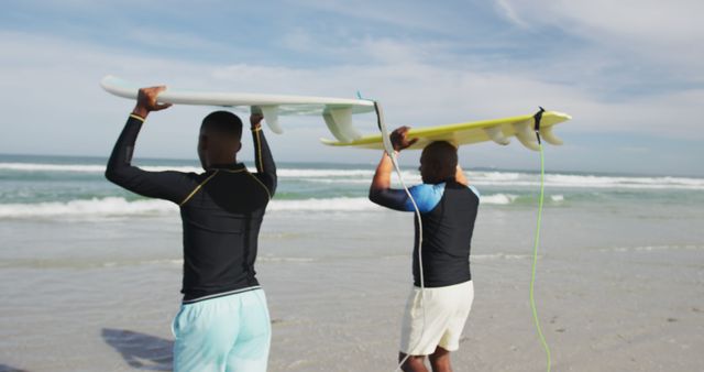 Two Surfers Carrying Surfboards Heading to Ocean on Sunny Beach - Download Free Stock Images Pikwizard.com