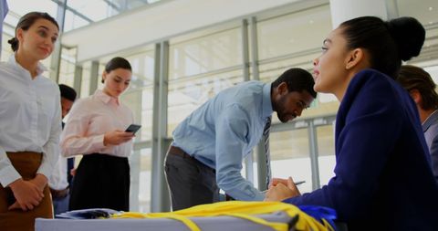 Business professionals queuing at conference registration
