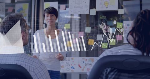 Businesswoman presenting data insights to team in modern office