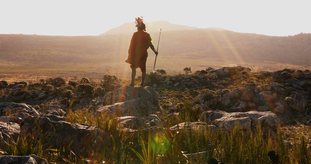 Warrior in Traditional Outfit Standing on Rocky Hills at Sunrise - Download Free Stock Images Pikwizard.com