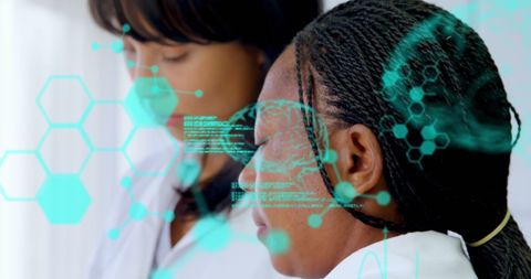 Diverse female scientists analyzing medical technology data