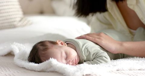 Mother and Baby Sharing Quiet Moment in Cozy Bedroom
