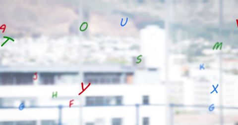 Colorful alphabet letters falling over cityscape background