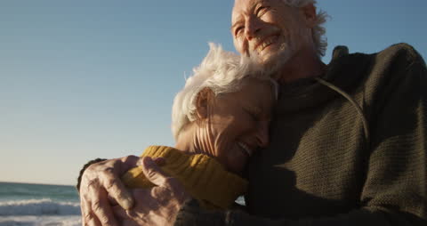 Senior Couple Embracing with Joy by the Beach