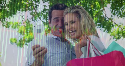 Couple checking smartphone with shopping bags under green trees and digital data overlay