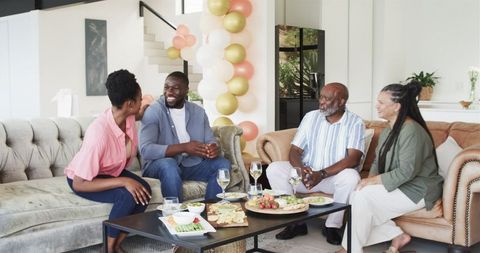 Family Celebration in Living Room with Pregnant Couple