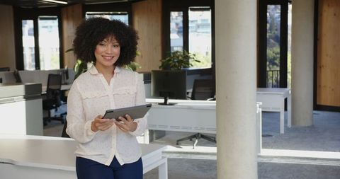 Professional African American Businesswoman in Modern Office with Tablet