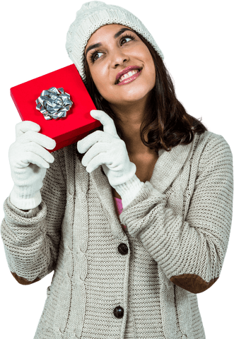 Festive woman holding red gift box glowing in winter attire transparent background