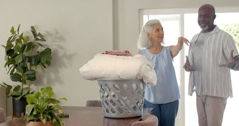Senior Couple Enjoying Time Together with Laundry at Home