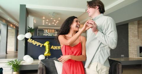 Happy Multiracial Couple Celebrating Anniversary at Home