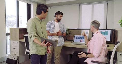 Collaborative Team Discussion in Modern Office with Data Analysis